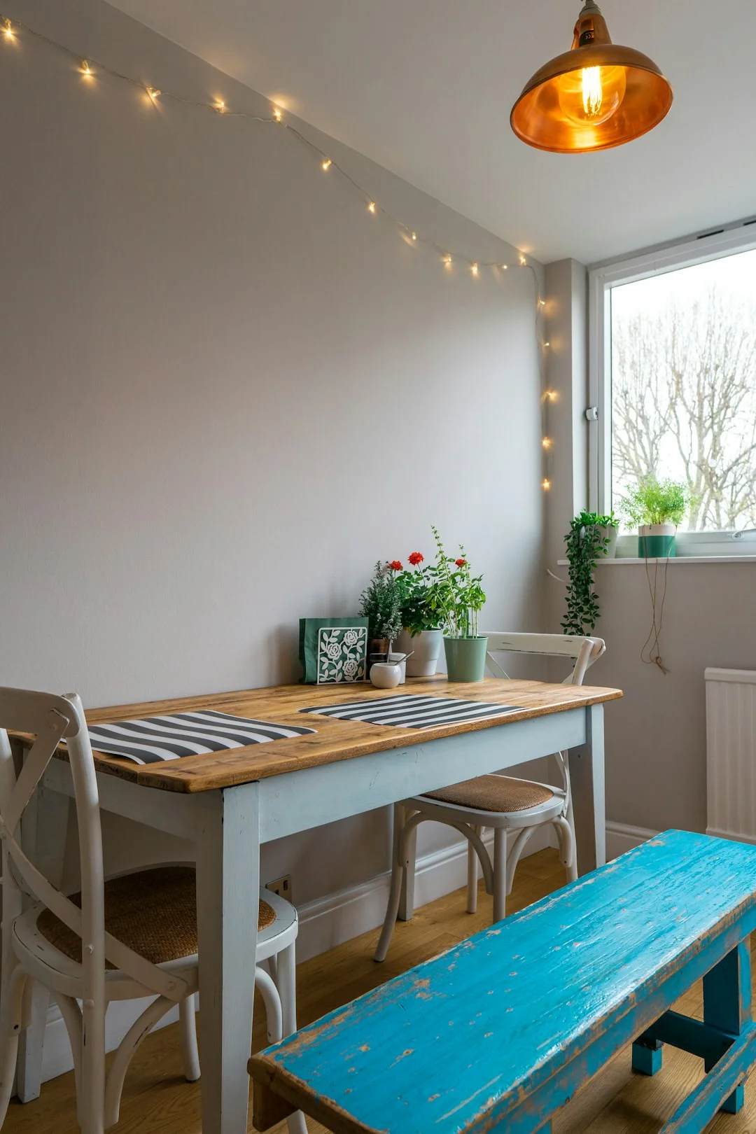 Covered with sheet sofa and floor lamp and packed cardboard boxes in light spacious room of new contemporary house